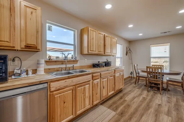 a kitchen with sink cabinets and dining table