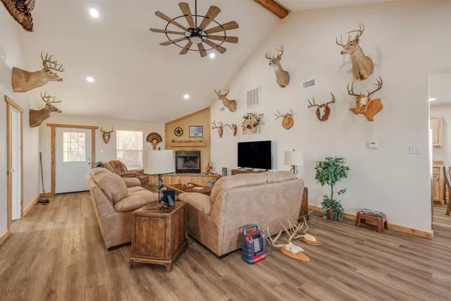 a living room with furniture and a wooden floor