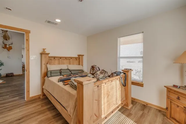 a bed sitting in a bedroom next to a window