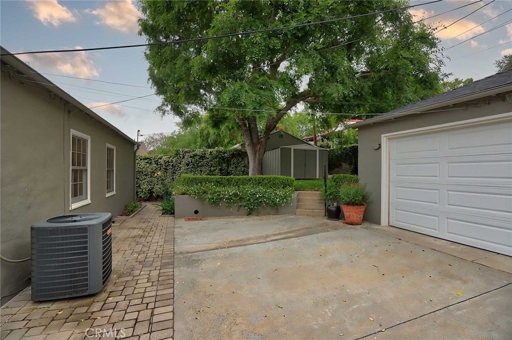 210 Sierra View Road Pasadena, CA 91105 - Photo 57 of 65 a view of a chair and table in the back yard of the house