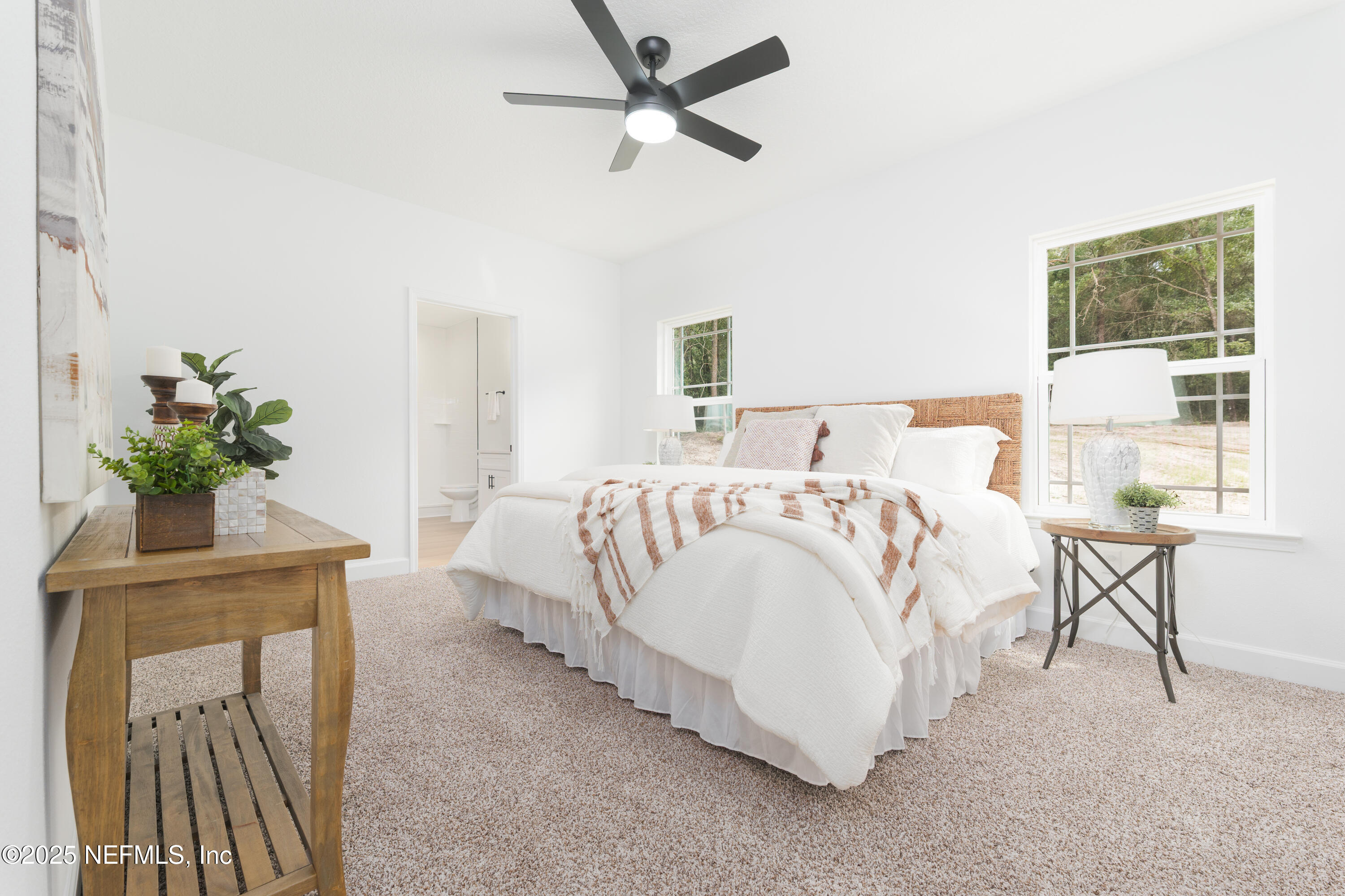 5729 Chippewa Avenue Keystone Heights, FL 32656 - Photo 11 of 20 a spacious bedroom with a bed and a table