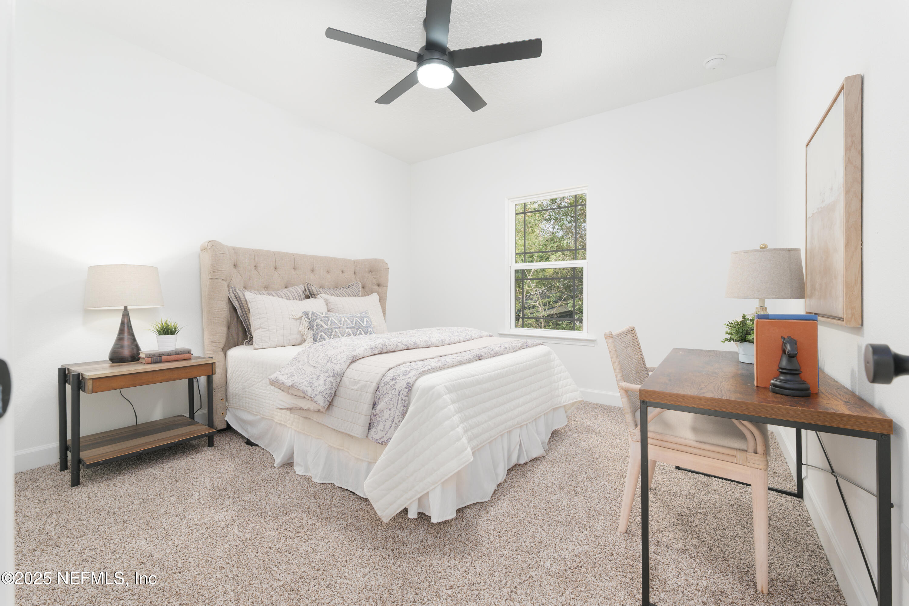 5729 Chippewa Avenue Keystone Heights, FL 32656 - Photo 16 of 20 a bedroom with a bed and a table in it