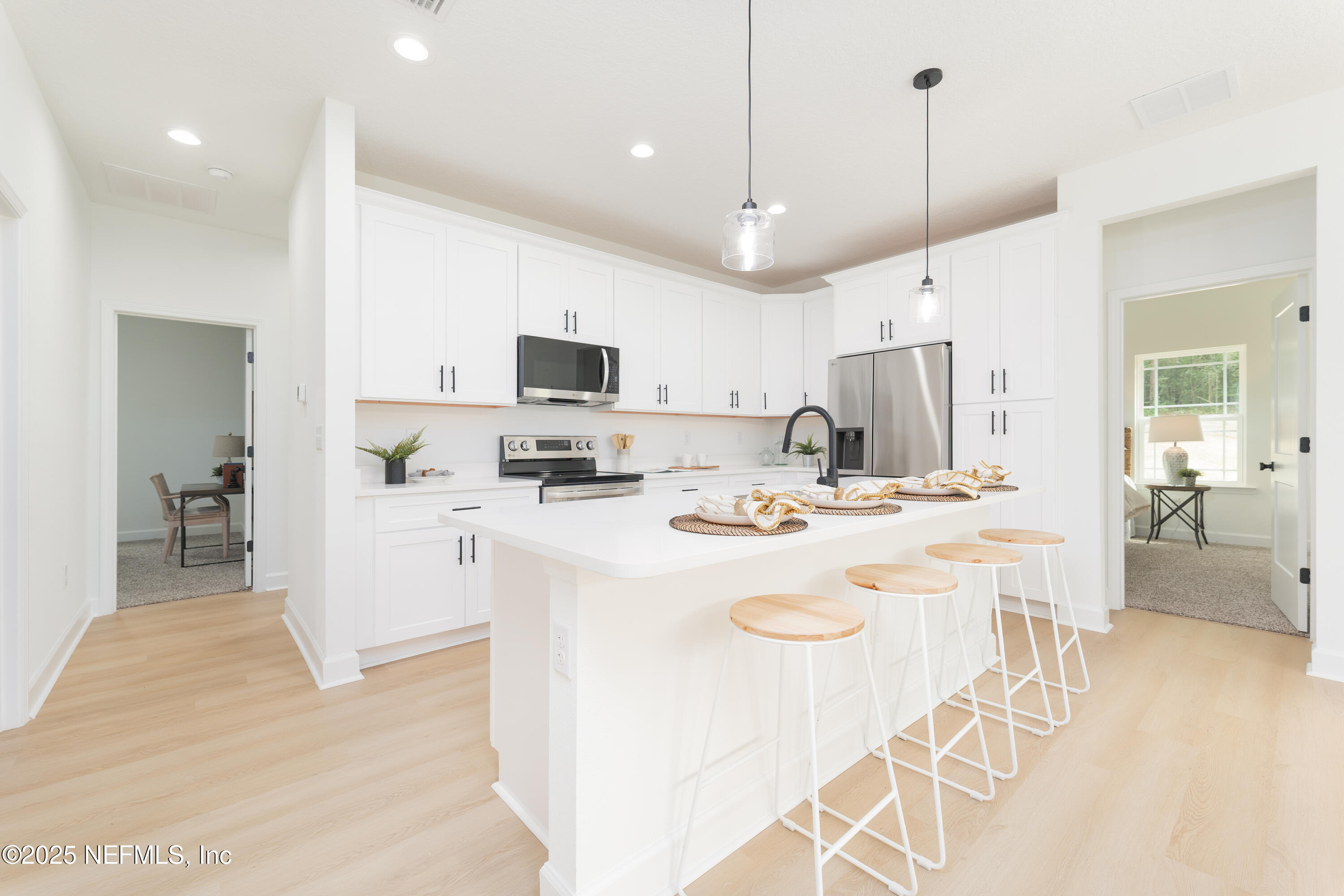 5729 Chippewa Avenue Keystone Heights, FL 32656 - Photo 3 of 20 a kitchen with kitchen island a white counter top space a sink stainless steel appliances and cabinets