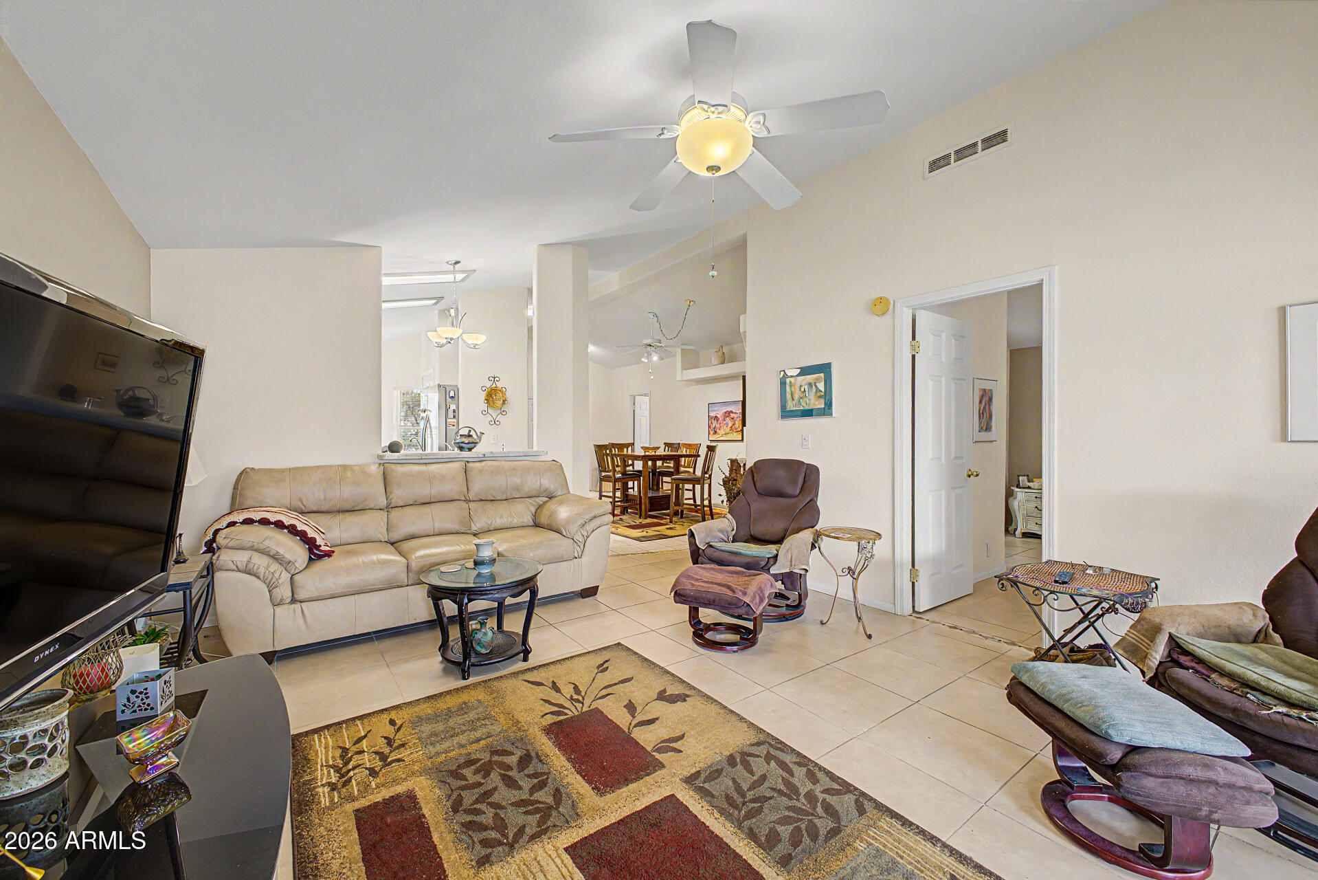 2101 South Meridian Road, Unit 45 Apache Junction, AZ 85120 - Photo 5 of 36 a living room with furniture a rug and a flat screen tv