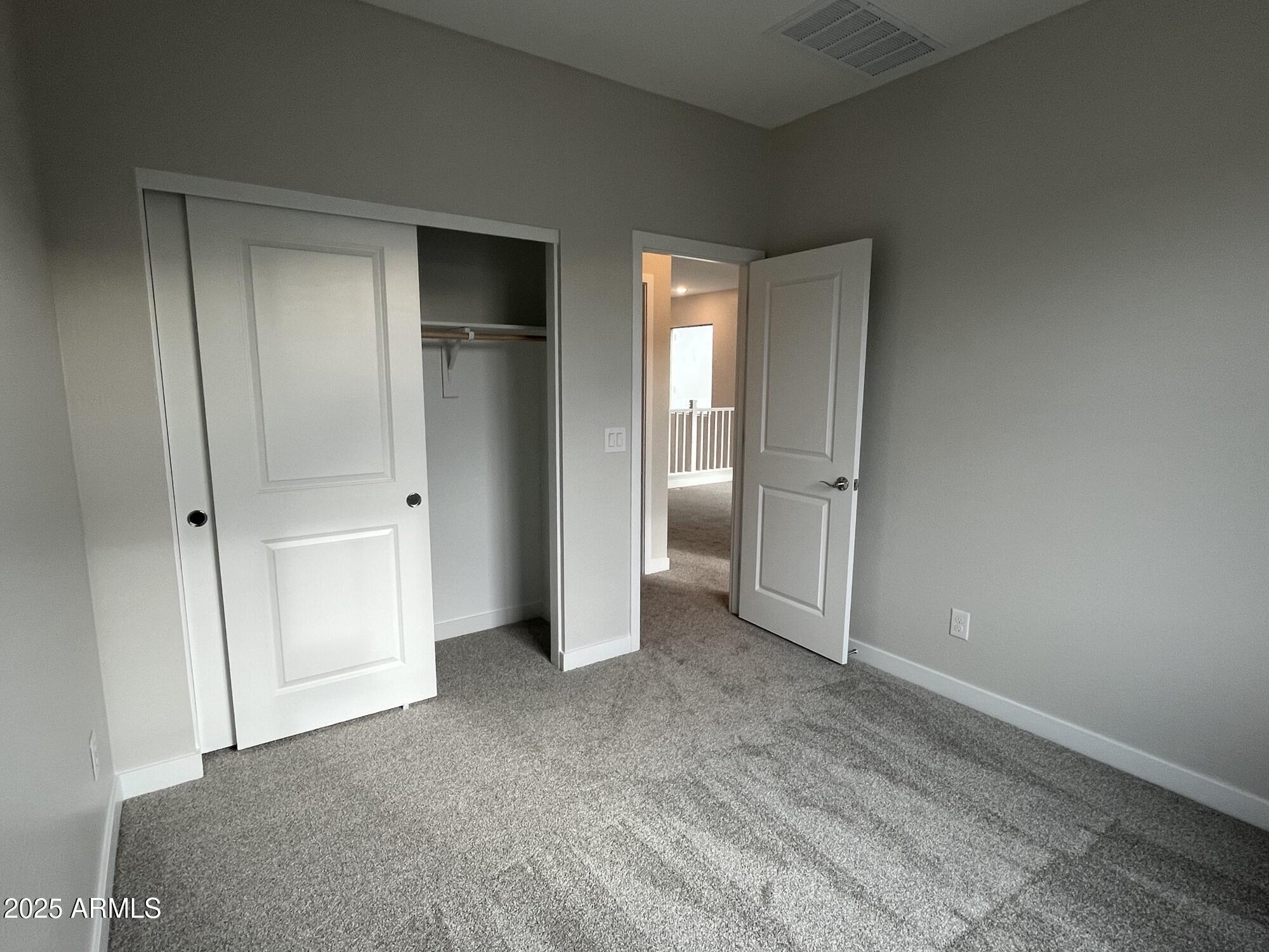 4515 South Pasteur Mesa, AZ 85212 - Photo 9 of 12 a view of a room with an empty space and wooden shelves