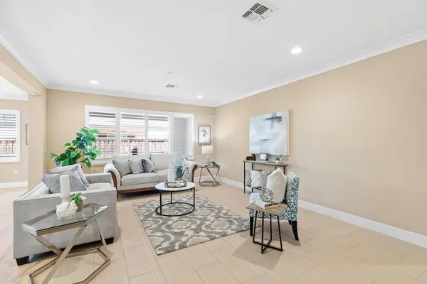 a kitchen with stainless steel appliances granite countertop a sink a stove a refrigerator and chairs