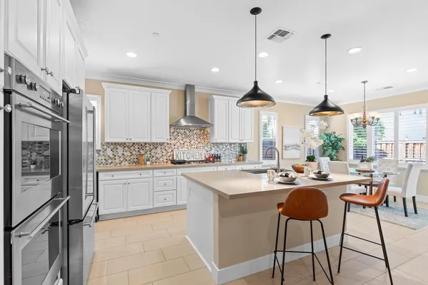 a kitchen with a refrigerator and cabinets