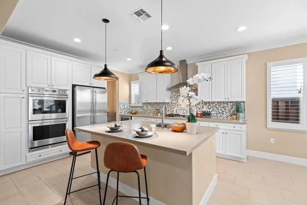 a kitchen with granite countertop a sink and cabinets