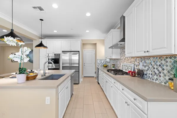 a dining room with furniture a chandelier and window