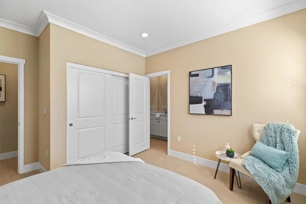 a spacious en suite bathroom with a granite countertop tub and a potted plant
