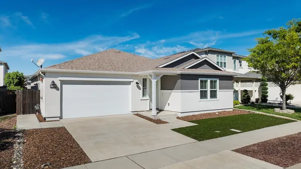 a front view of a house with a yard