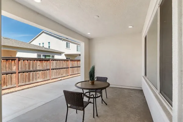 an aerial view of a house with a garden and lake view