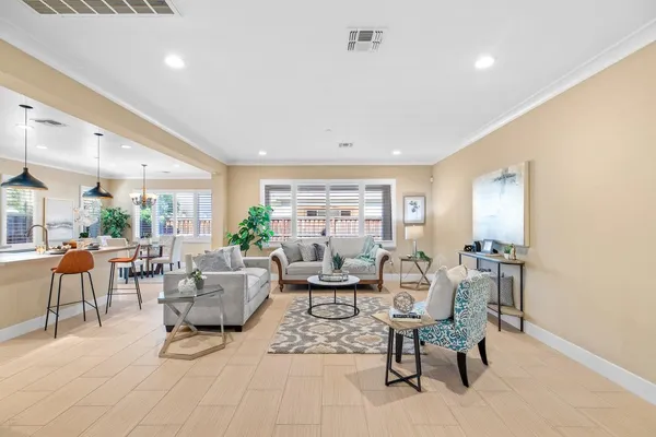 a living room with furniture and a large mirror