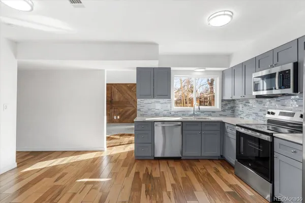 a kitchen with granite countertop a stove and a sink