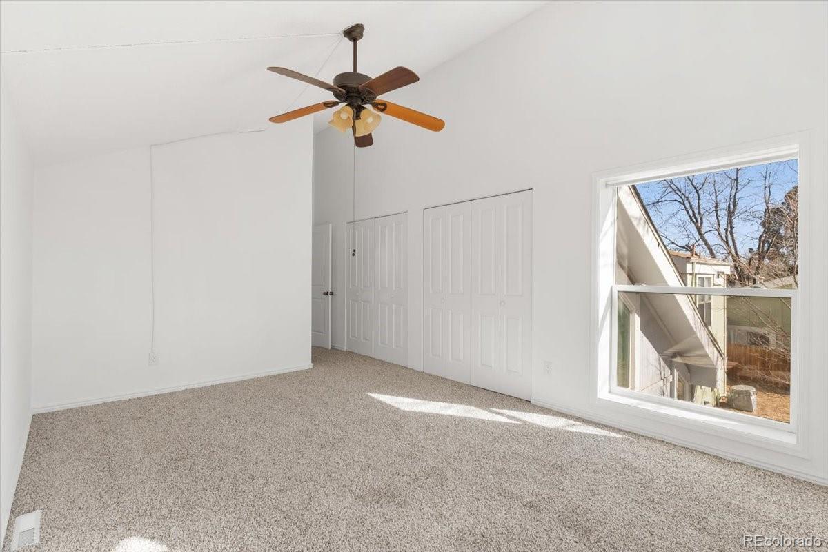 16222 East Rice Place, Unit B Aurora, CO 80015 - Photo 20 of 31 a view of a livingroom with a ceiling fan and window
