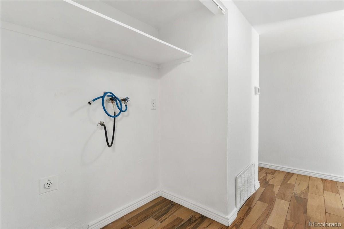 16222 East Rice Place, Unit B Aurora, CO 80015 - Photo 26 of 31 a view of a room with wooden floor
