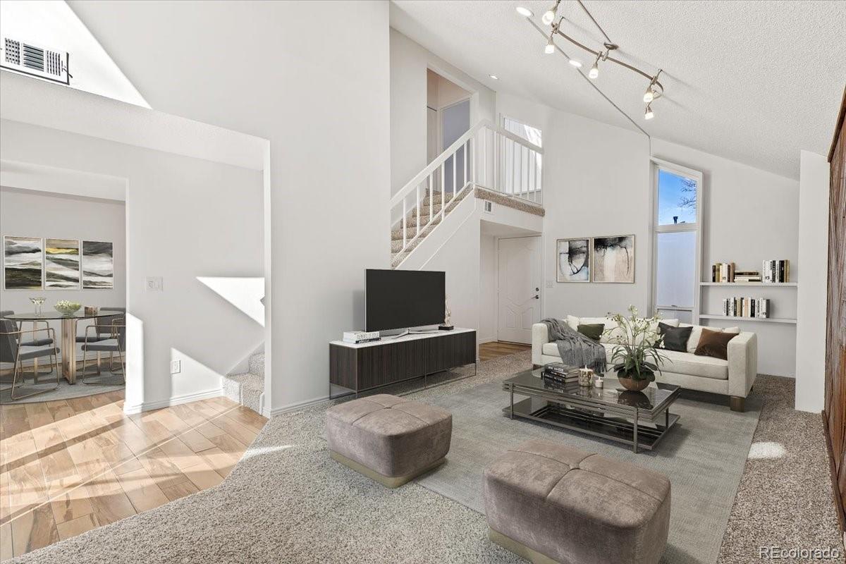 16222 East Rice Place, Unit B Aurora, CO 80015 - Photo 4 of 31 a living room with furniture and a flat screen tv