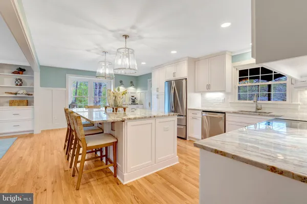 a kitchen with refrigerator and cabinets