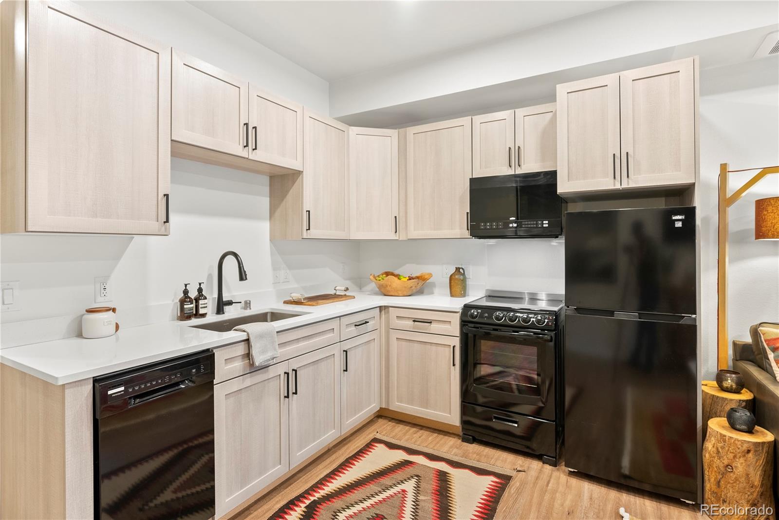2155 Bighorn Road, Unit 101 Georgetown, CO 80444 - Photo 7 of 35 a kitchen with a sink stove and refrigerator