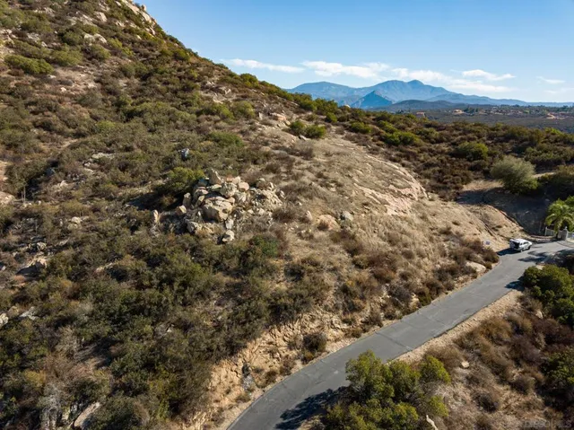 a view of a large mountain with mountains in the background