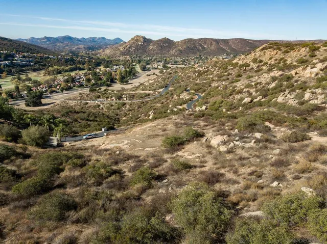 a view of a large building with mountains in the background