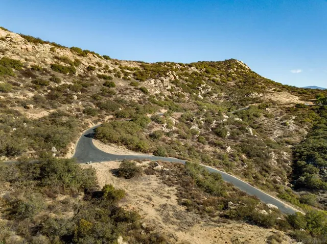 a view of a large mountain with mountains in the background