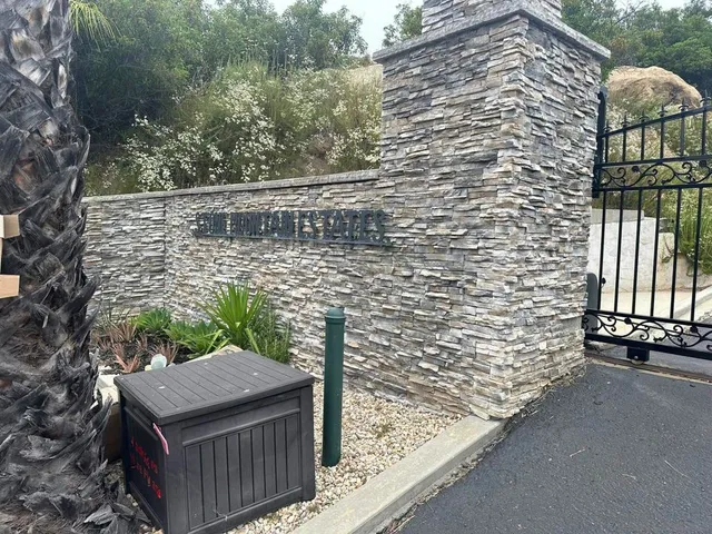 a view of a large building with mountains in the background