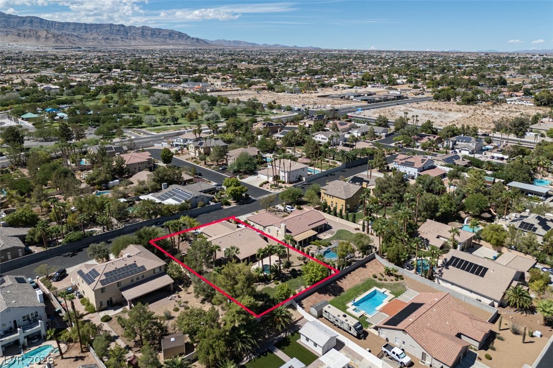 4670 Los Rancheros Avenue Las Vegas, NV 89129 - Photo 55 of 57 An expansive neighborhood view reveals this property nestled among mature trees and mountain backdrops.