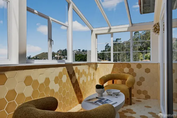 a living room with a couch and a floor to ceiling window