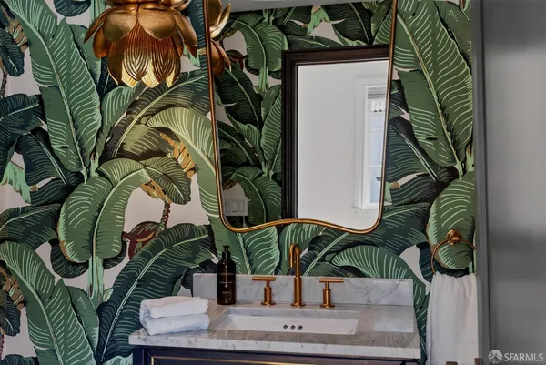 a vase of flowers sitting on a floor