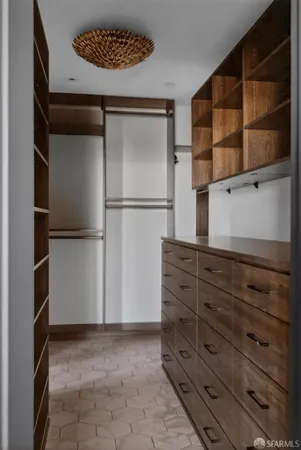 a view of walk in closet with empty racks