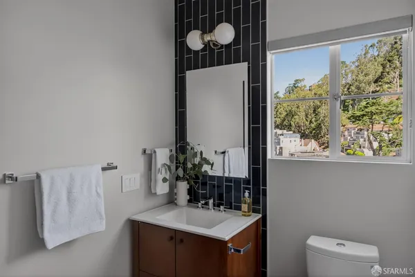 a bathroom with a sink vanity granite and a mirror