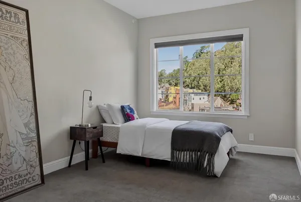 a bed room with a bed and a window