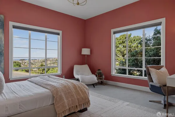 a bedroom with a bed and a chair