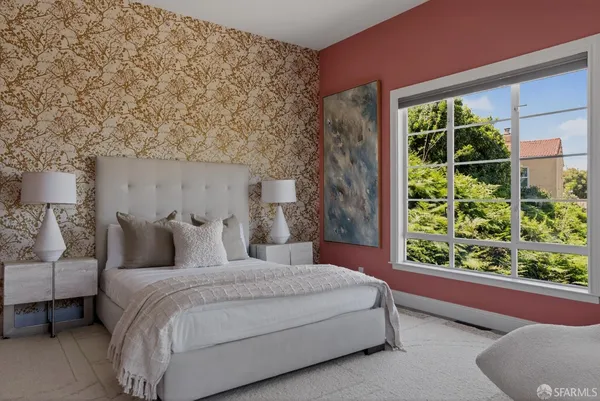 a bedroom with a large bed and a window with outer view