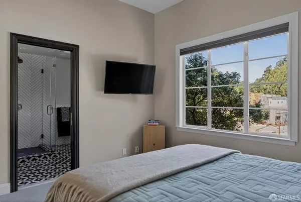 a bedroom with a bed and a television