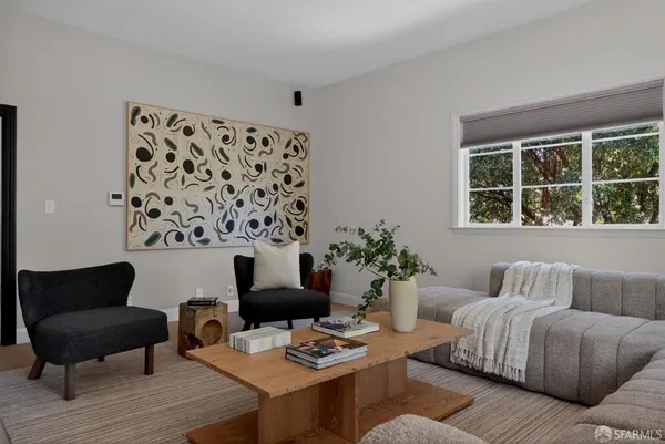 a living room with furniture and a potted plant