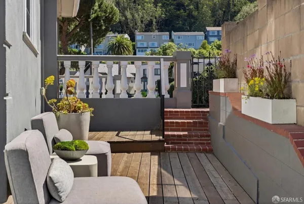 a view of a chairs and table in the balcony