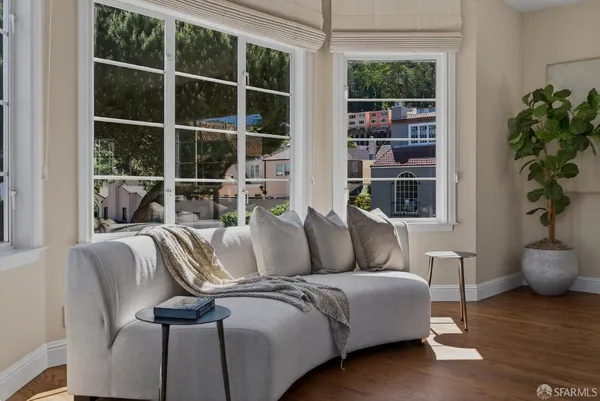 a living room with furniture potted plant and a window