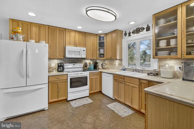 a kitchen with a refrigerator stove and sink