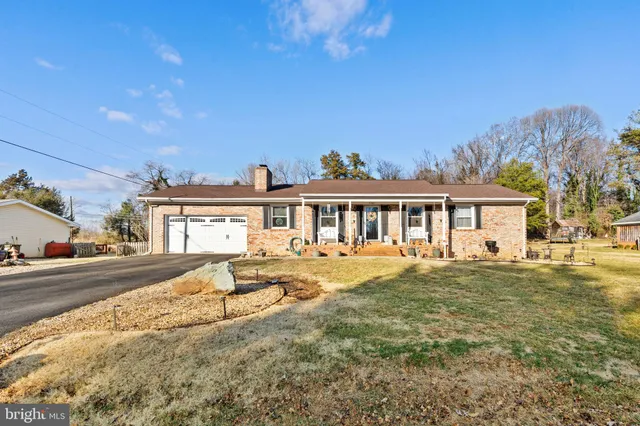 a front view of house with yard outdoor seating and barbeque oven