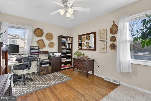 a view of a patio with table and chairs with wooden floor and fence