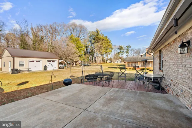 a swimming pool with outdoor seating and yard