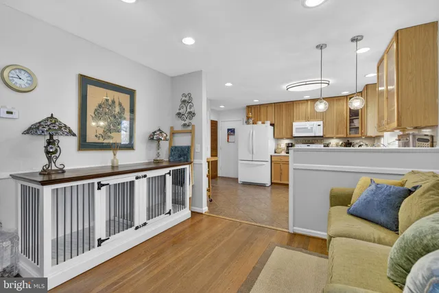 a living room with furniture and kitchen view