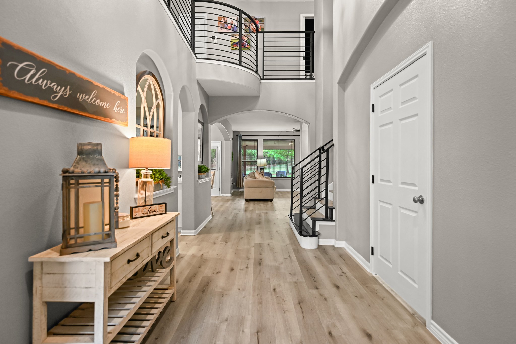 5528 Wild Foxglove Road Spicewood, TX 78669 - Photo 3 of 38 a view of a hallway with wooden floor and staircase