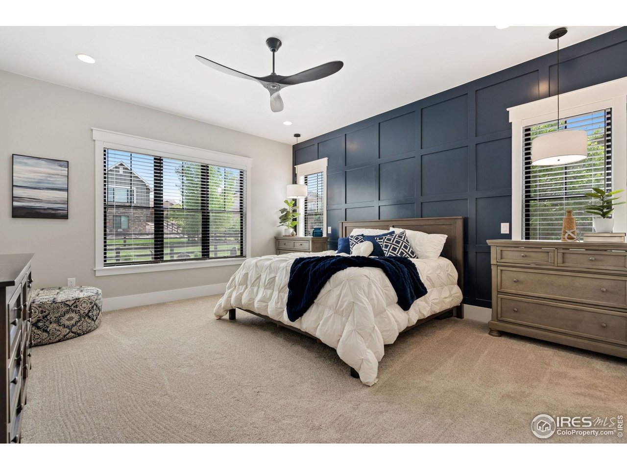 6475 Sanctuary Drive Windsor, CO 80550 - Photo 17 of 37 a bed room with a bed and a large window