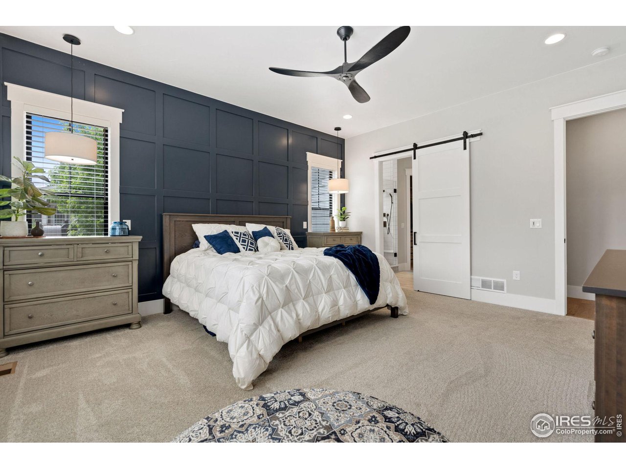 6475 Sanctuary Drive Windsor, CO 80550 - Photo 18 of 37 a bedroom with a bed and a ceiling fan