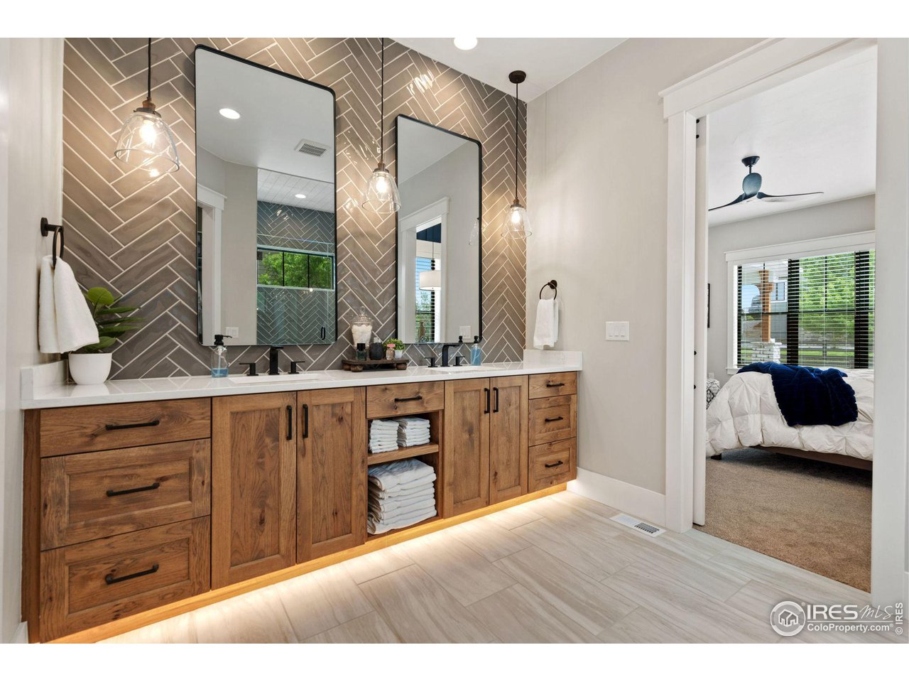 6475 Sanctuary Drive Windsor, CO 80550 - Photo 19 of 37 a en suite bathroom with a granite countertop sink and a mirror