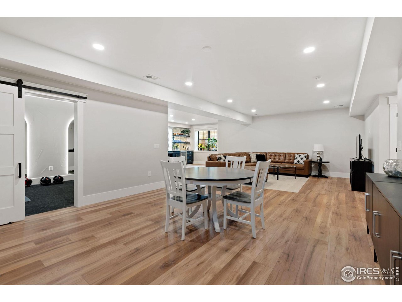 6475 Sanctuary Drive Windsor, CO 80550 - Photo 21 of 37 a view of a dining room with furniture and wooden floor