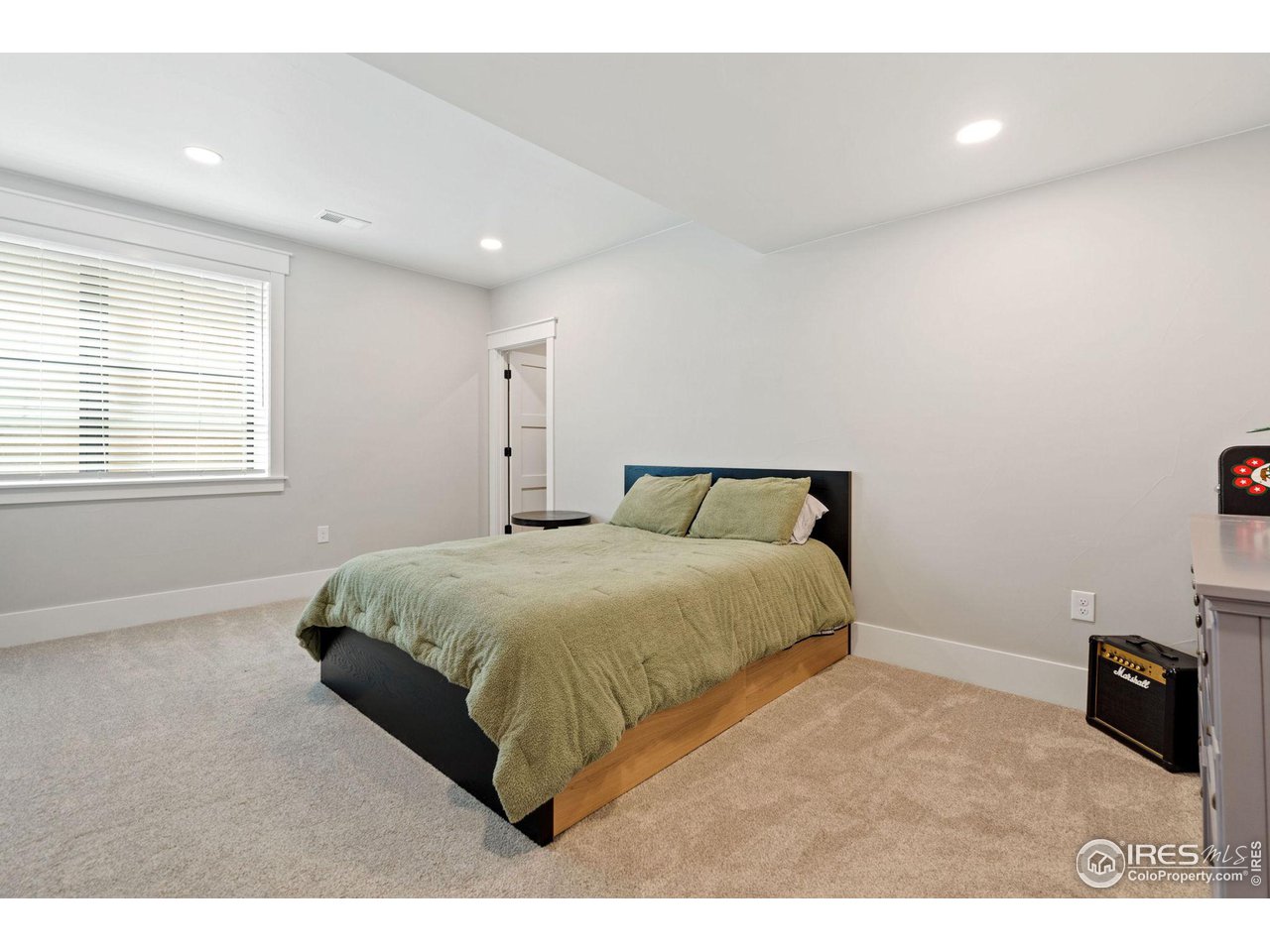6475 Sanctuary Drive Windsor, CO 80550 - Photo 26 of 37 a bedroom with a bed and a television